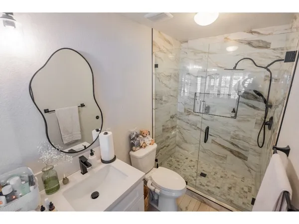 a bathroom with a sink toilet and shower