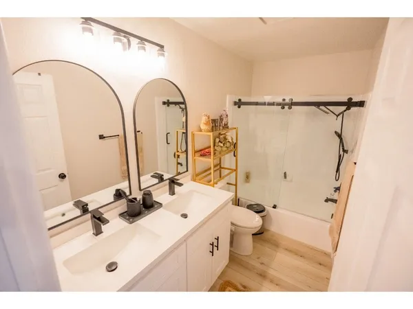 a bathroom with a sink mirror toilet and shower