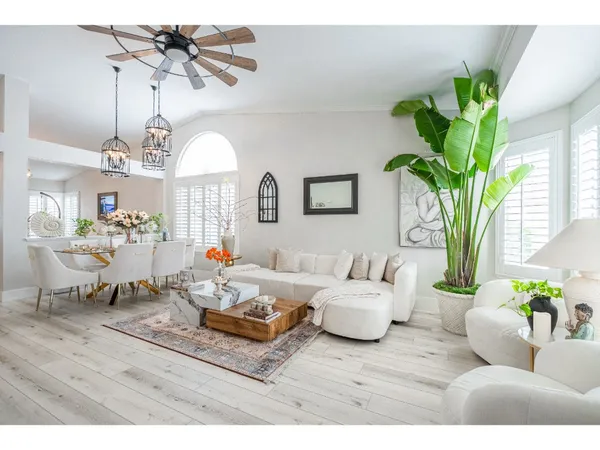 a living room with furniture and a chandelier