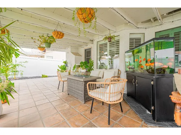a dining room with furniture and a potted plant