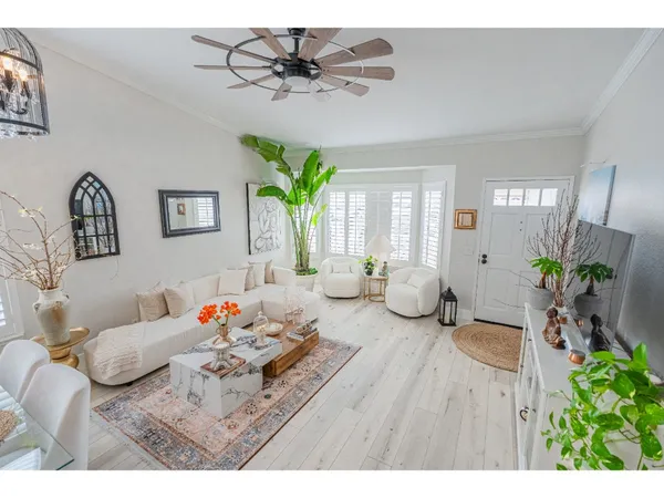 a living room with furniture and a dining table