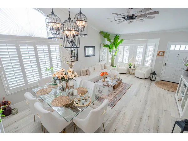 a living room with furniture dining table and a chandelier