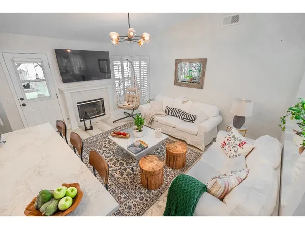 a living room with fireplace furniture and a flat screen tv