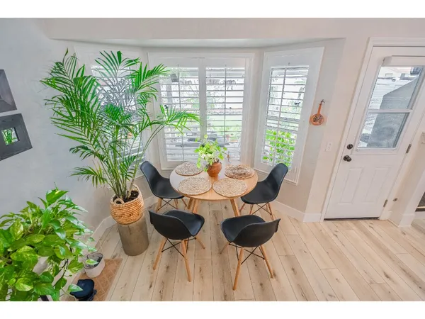 a view of a dining room with furniture and a potted plant
