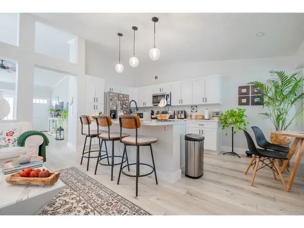 a kitchen with dining table and chairs