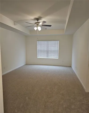 a view of a livingroom with a ceiling fan and window