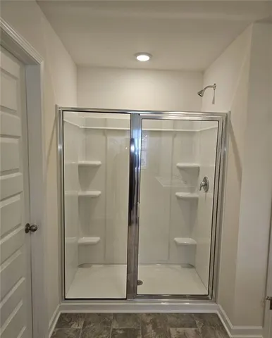 a bathroom with a glass shower door