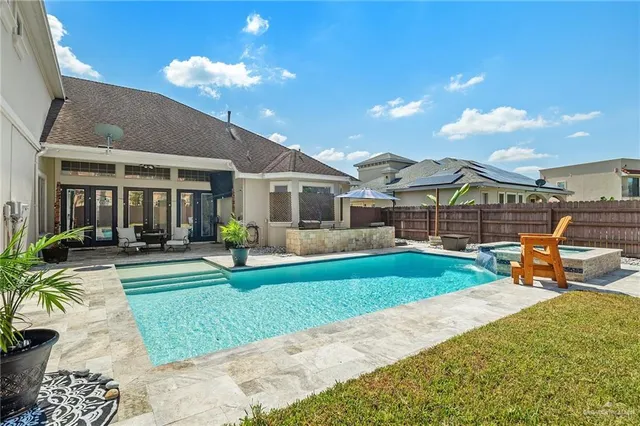 a view of a house with swimming pool and sitting area