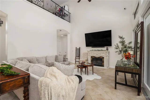 a living room with furniture a fireplace and a flat screen tv