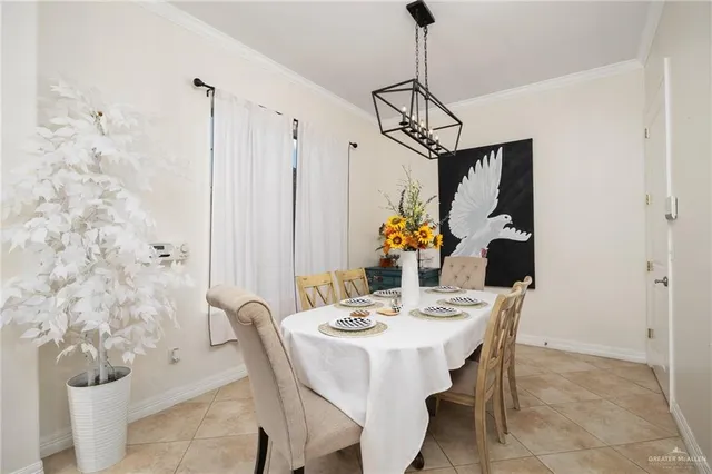 a view of a dining room with furniture and chandelier