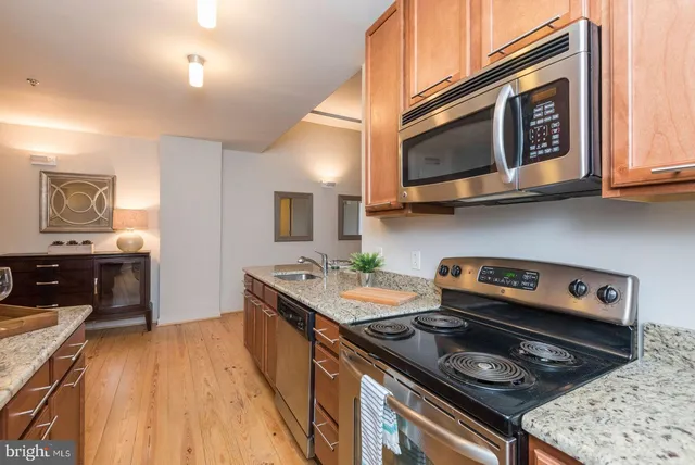 a kitchen with stainless steel appliances granite countertop a stove and a microwave