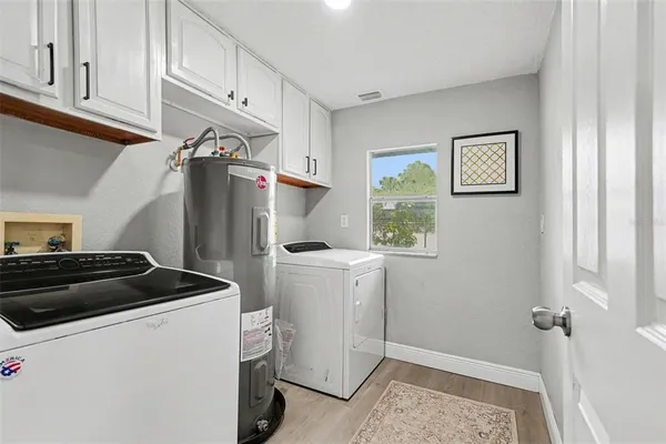 a kitchen with a refrigerator and a stove top oven