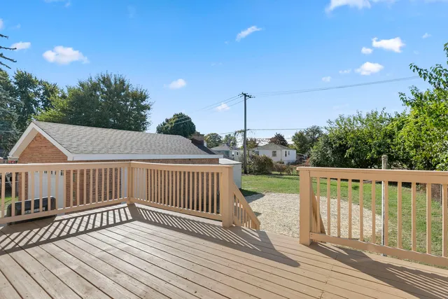 a view of a wooden deck and a yard