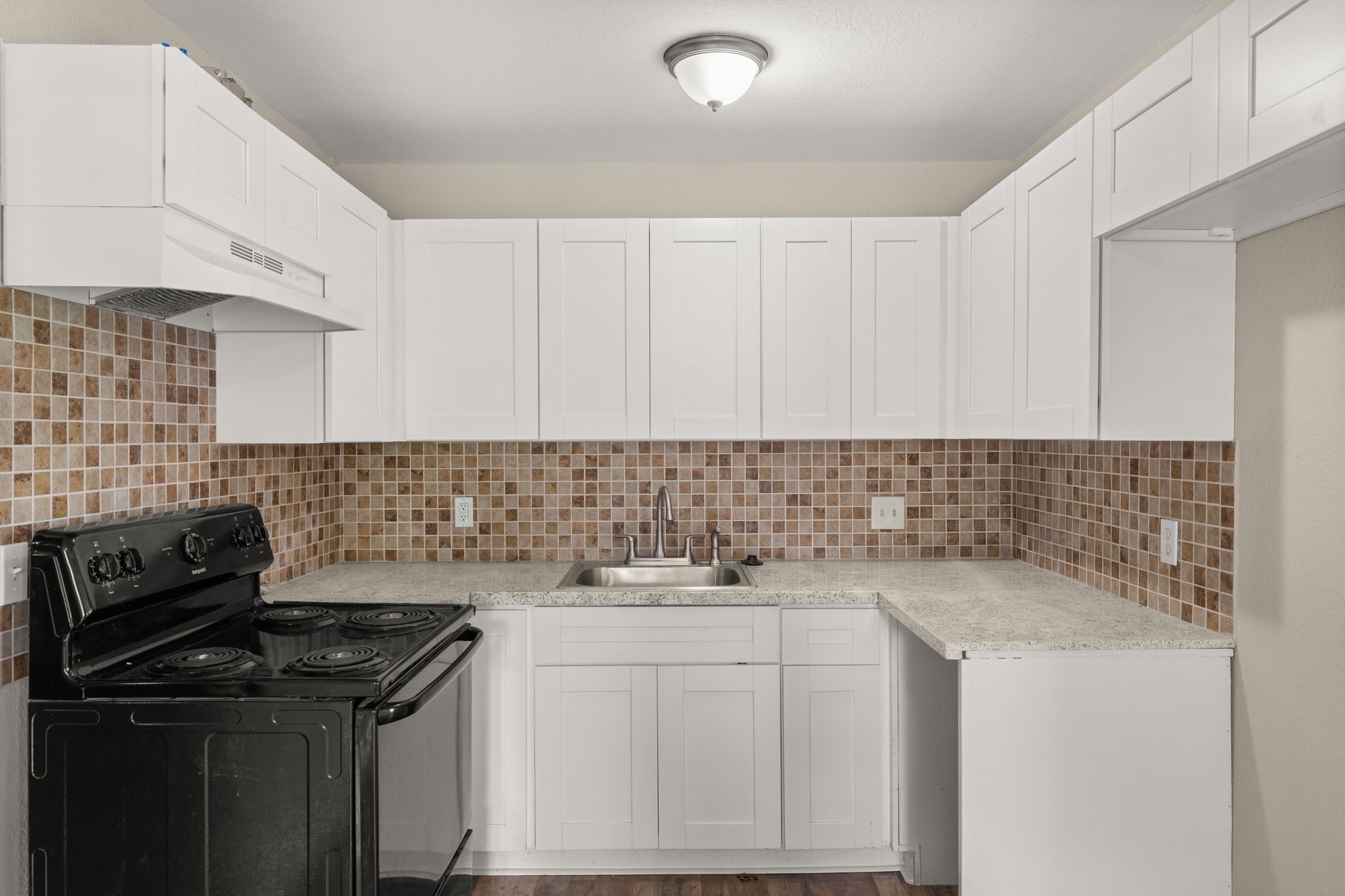 3031 Friar Point Road Houston, TX 77051 - Photo 5 of 15 a kitchen with a sink stove and cabinets