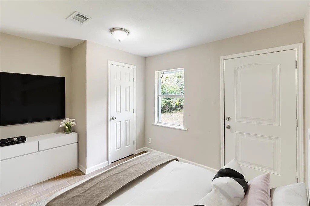 3031 Friar Point Road Houston, TX 77051 - Photo 9 of 15 a bedroom with a bed and a flat screen tv