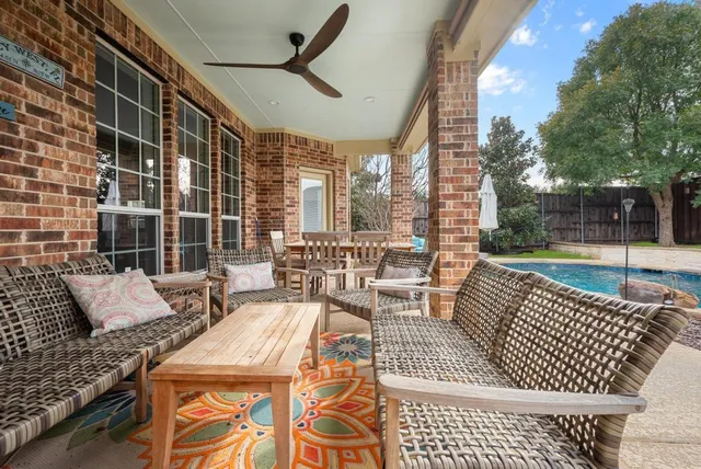 a view of a patio with couches chairs and wooden floor