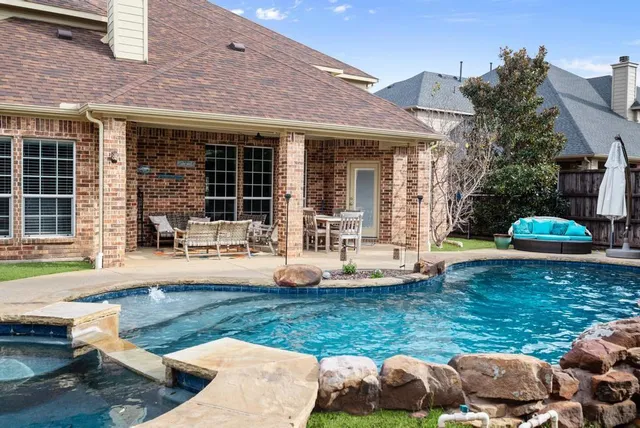 a front view of a house with a yard table and chairs