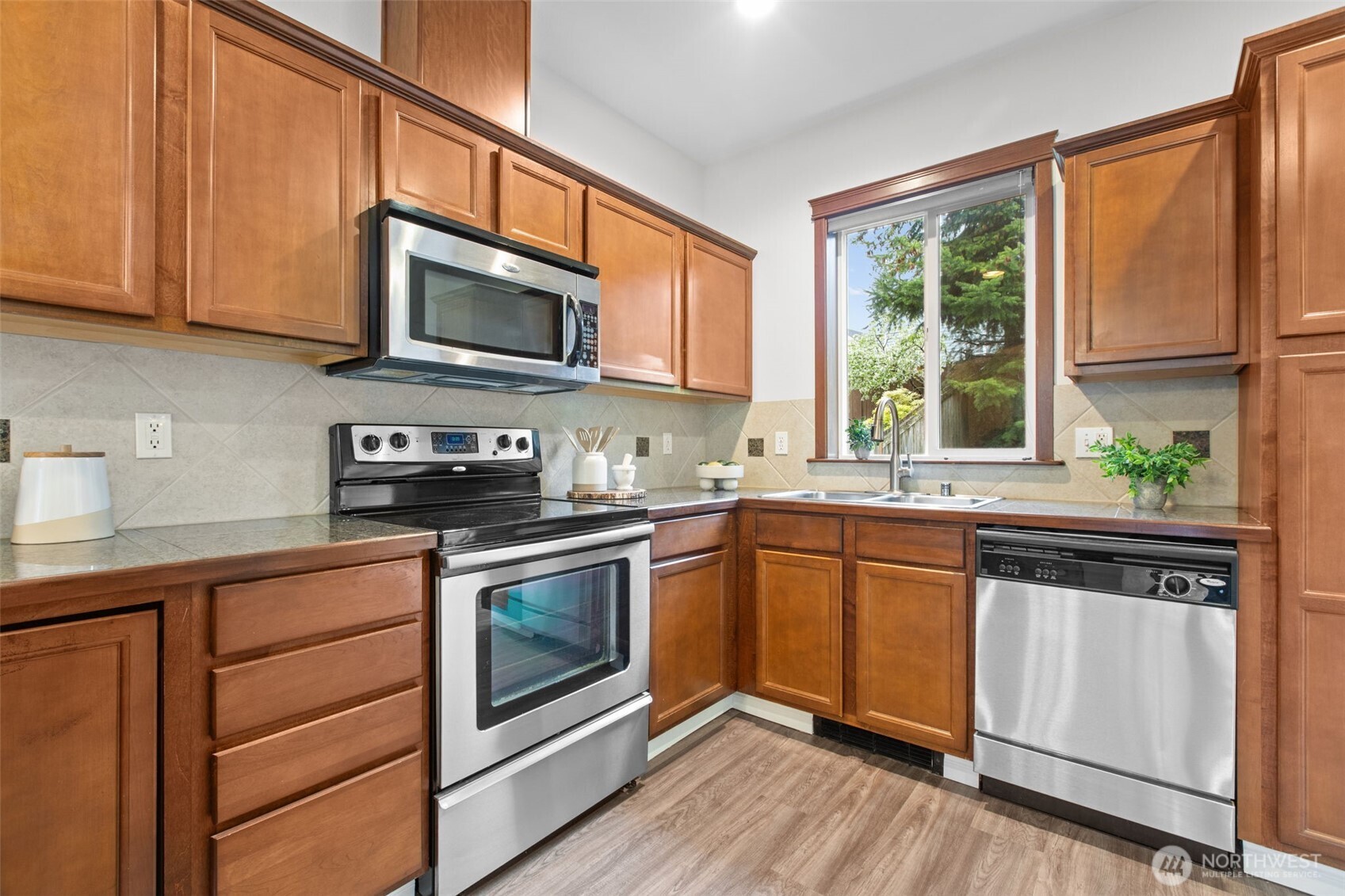 532 Pilchuck Path Everett, WA 98201 - Photo 4 of 37 a kitchen with stainless steel appliances granite countertop a stove a sink and a microwave