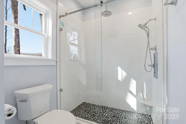 a bathroom with a shower a toilet and a shower