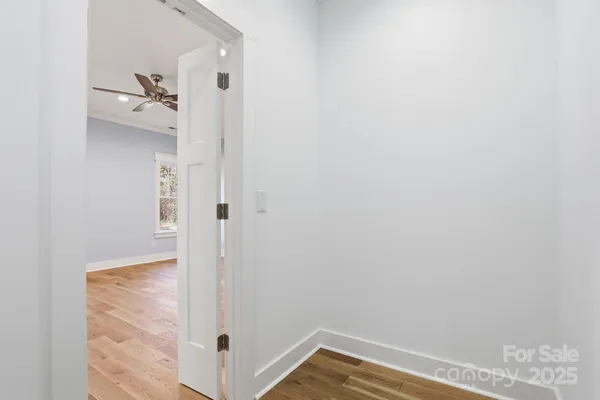 a view of a hallway with wooden floor