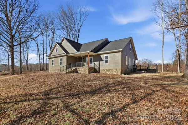 a front view of a house with a dirt yard