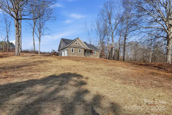 a big house with large trees and a big yard