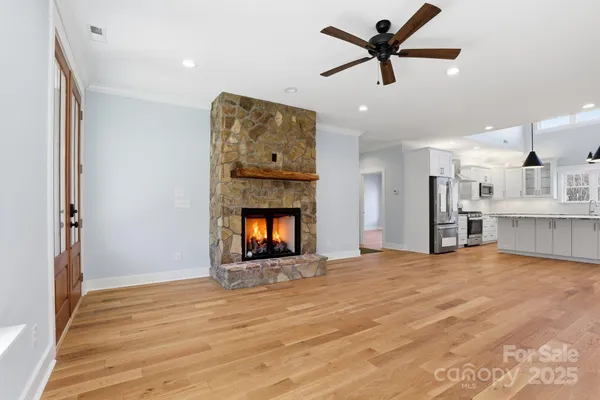 a view of an empty room with a fireplace