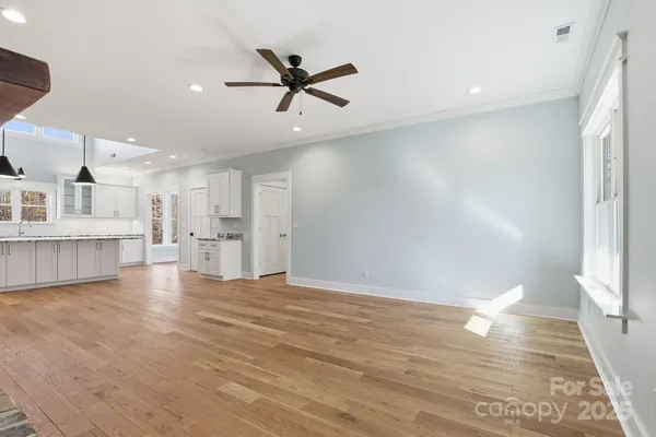 a view of empty room with wooden floor and window