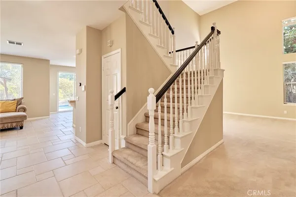 a view of staircase with lots of frames and couches