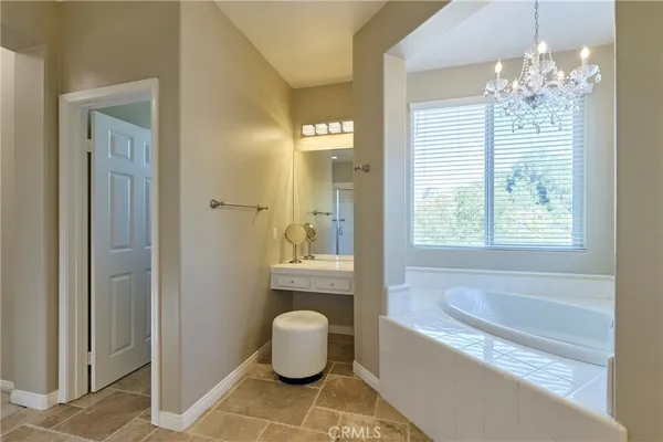 a spacious bathroom with a bathtub and shower