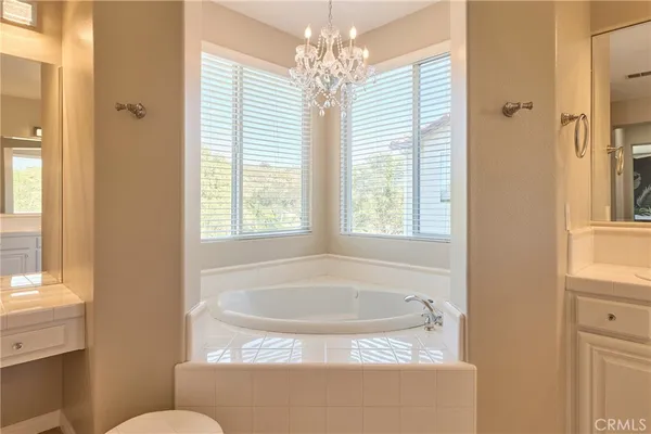 a bath tub sitting in a bathroom next to a window
