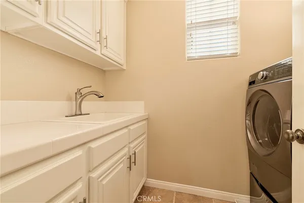 a utility room with a sink dryer and washer
