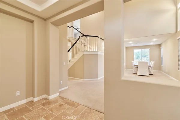 a view of a hallway with wooden floor and a bathroom