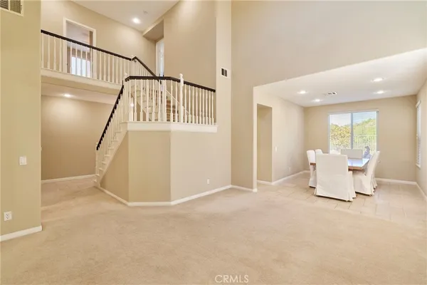 a view of an empty room with furniture and a window