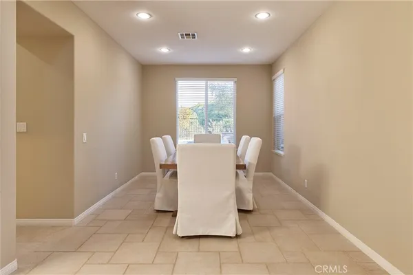 a view of a dining room with furniture and a window