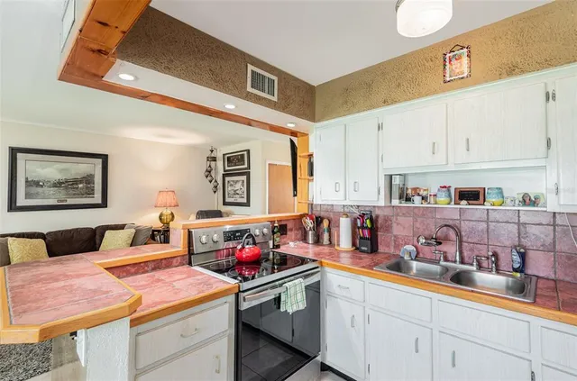 a kitchen that has a cabinets and a stove