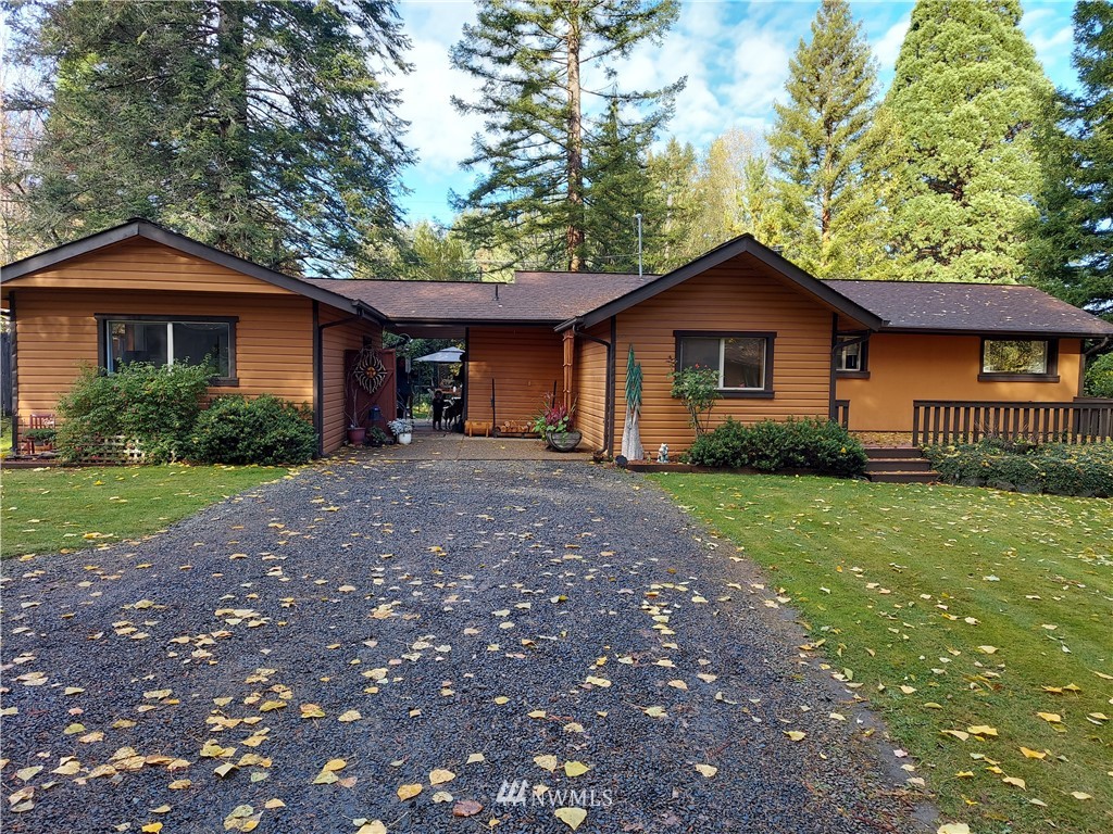 540 Northeast Beck Road Belfair, WA 98528 - Photo 1 of 1 a front view of a house with a garden