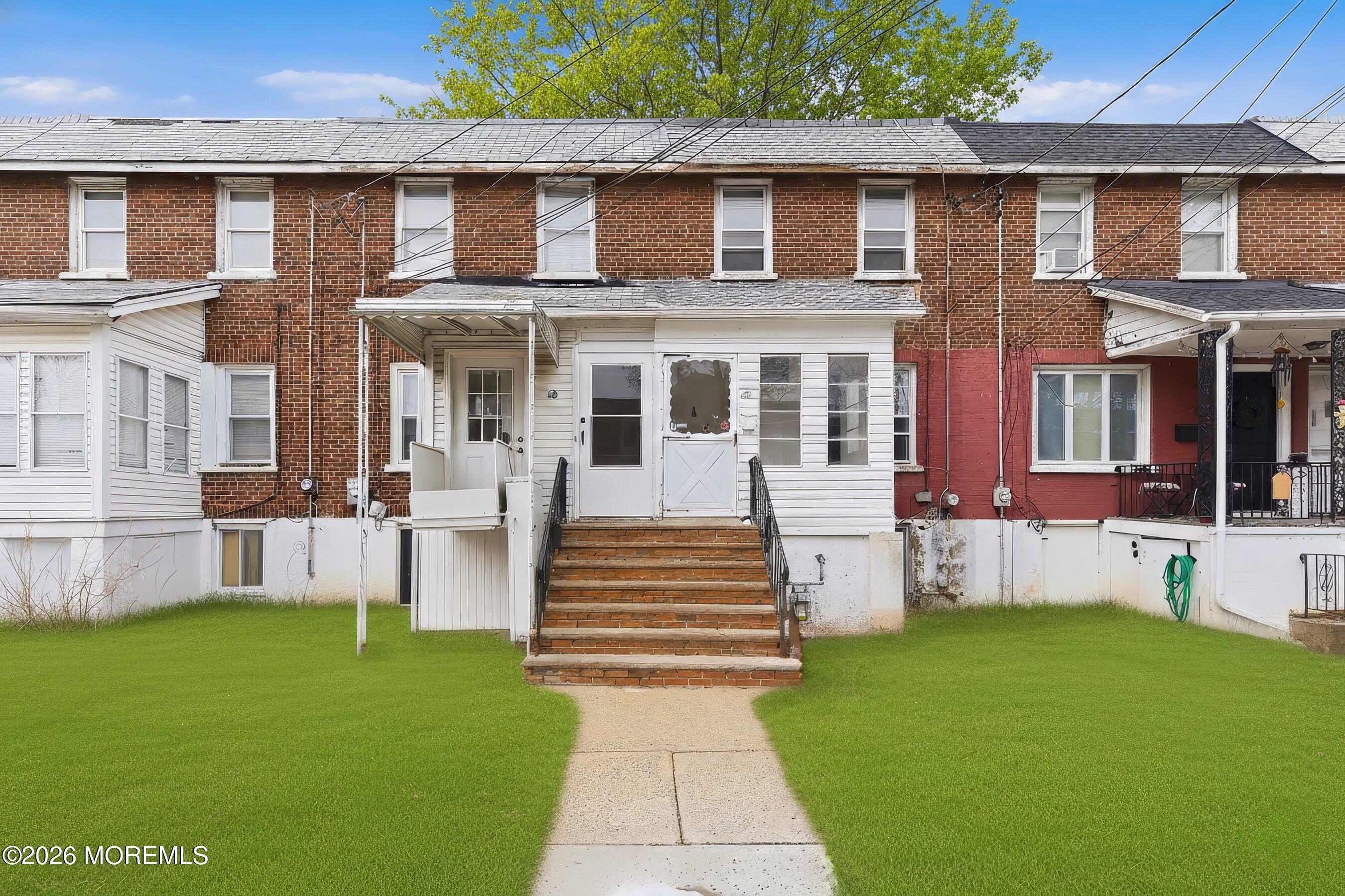 a front view of a house with a yard