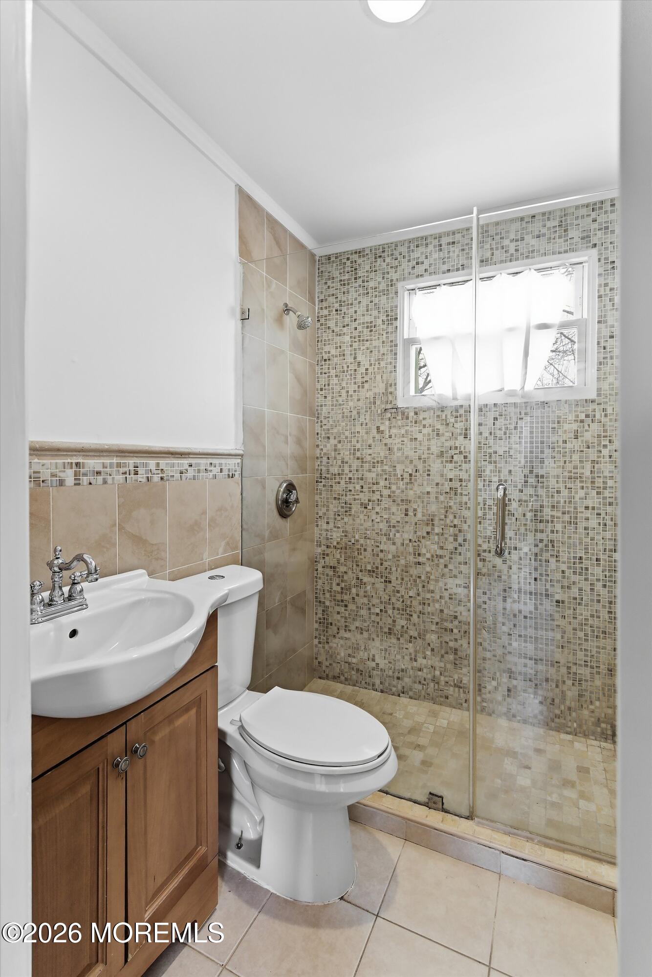46 West 12th Street Linden, NJ 07036 - Photo 12 of 18 a bathroom with a sink a toilet and shower