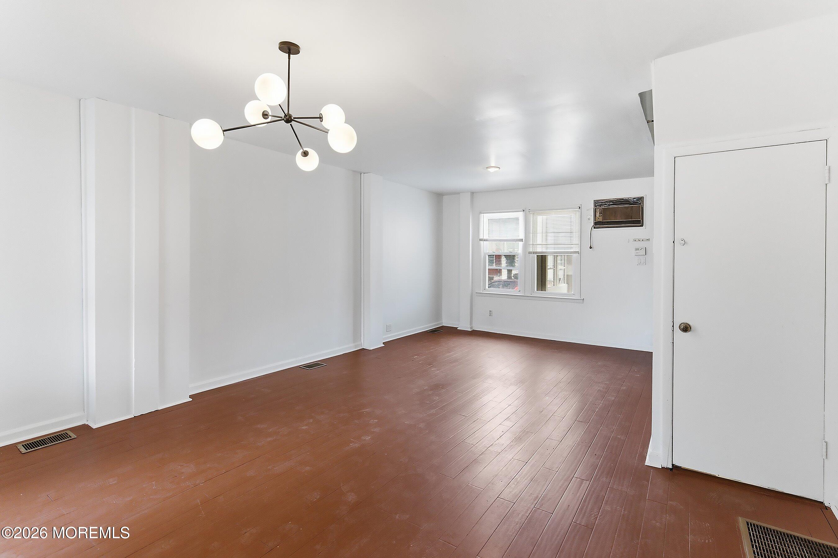46 West 12th Street Linden, NJ 07036 - Photo 6 of 18 a view of an empty room with wooden floor and windows