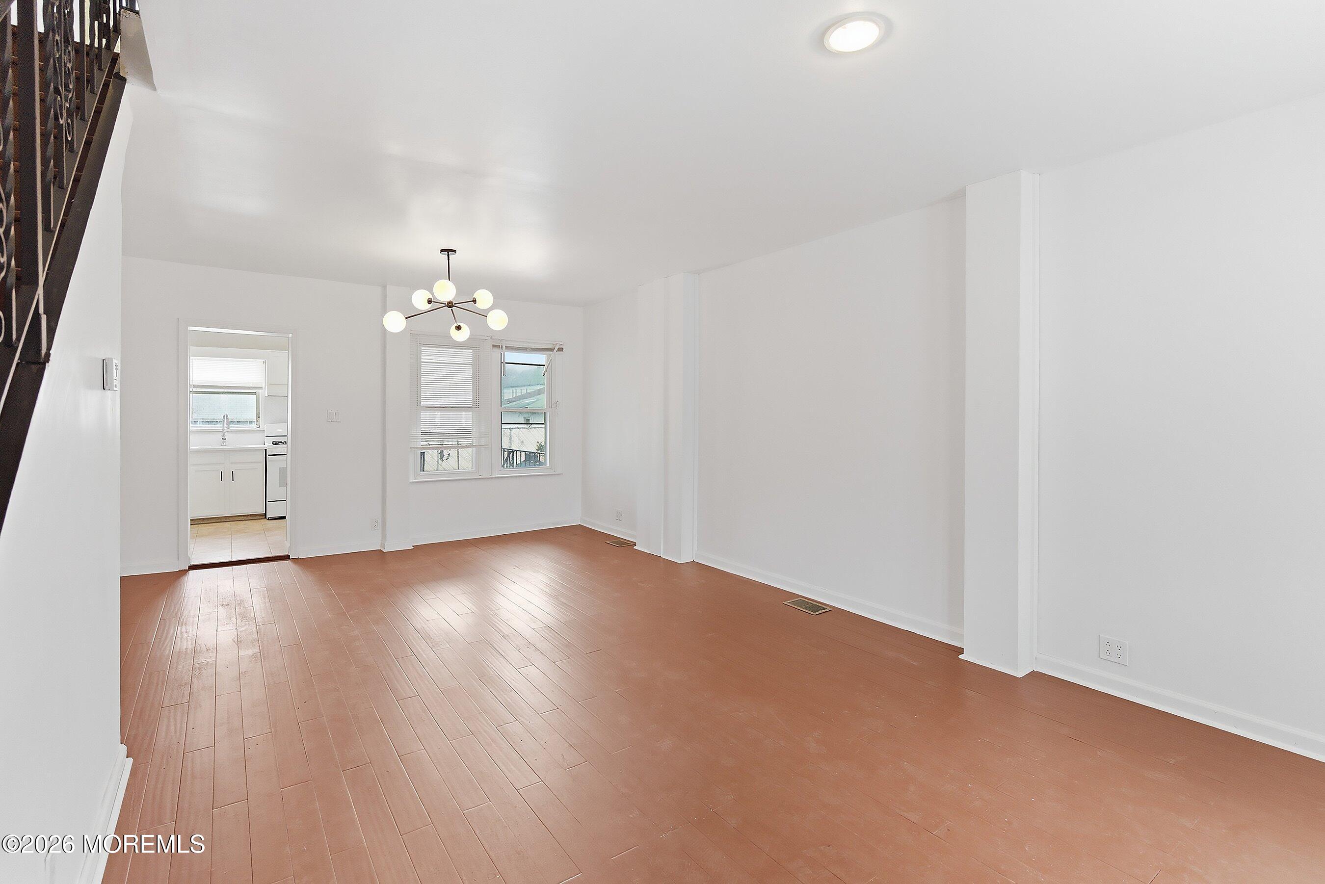 46 West 12th Street Linden, NJ 07036 - Photo 8 of 18 an empty room with wooden floor and windows
