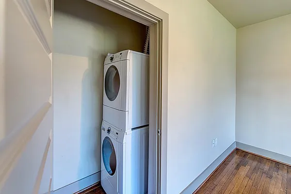 a view of a livingroom with wooden floor and a ceiling fan