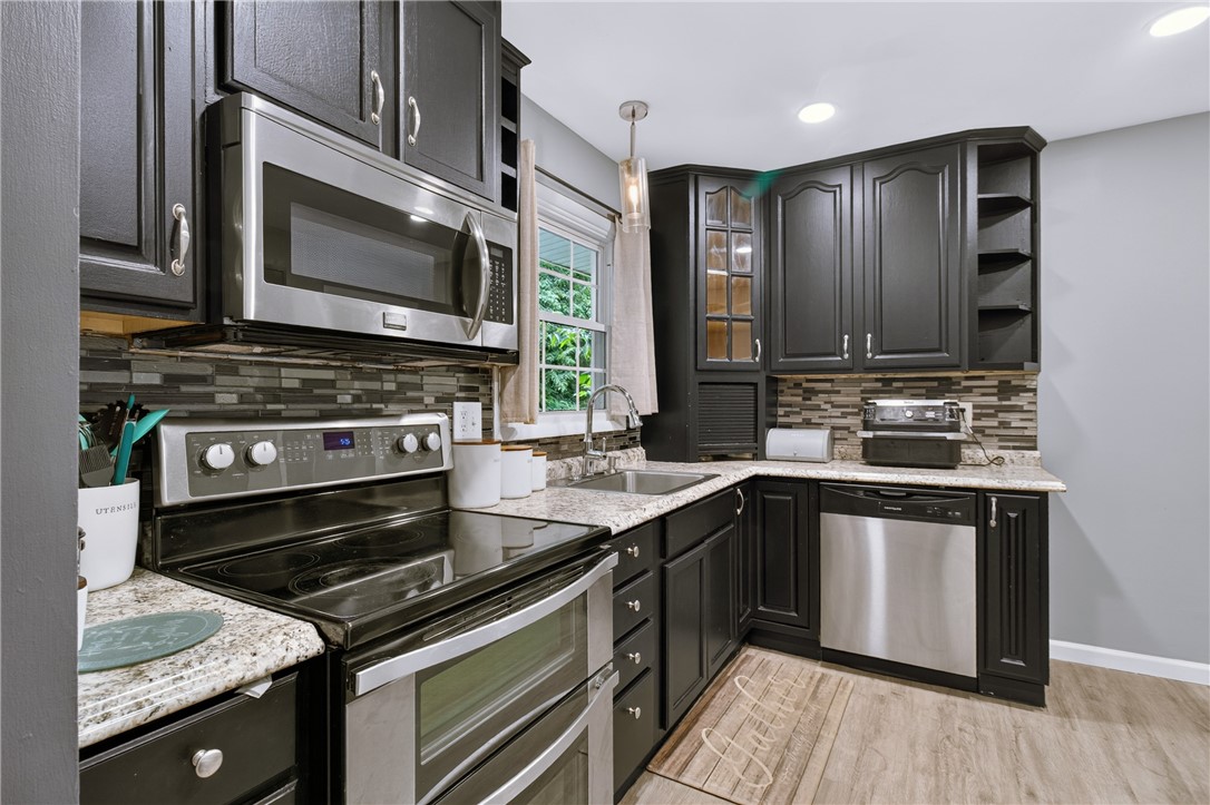 50 Heather Drive Rochester, NY 14625 - Photo 10 of 31 The kitchen features a newer tile backsplash