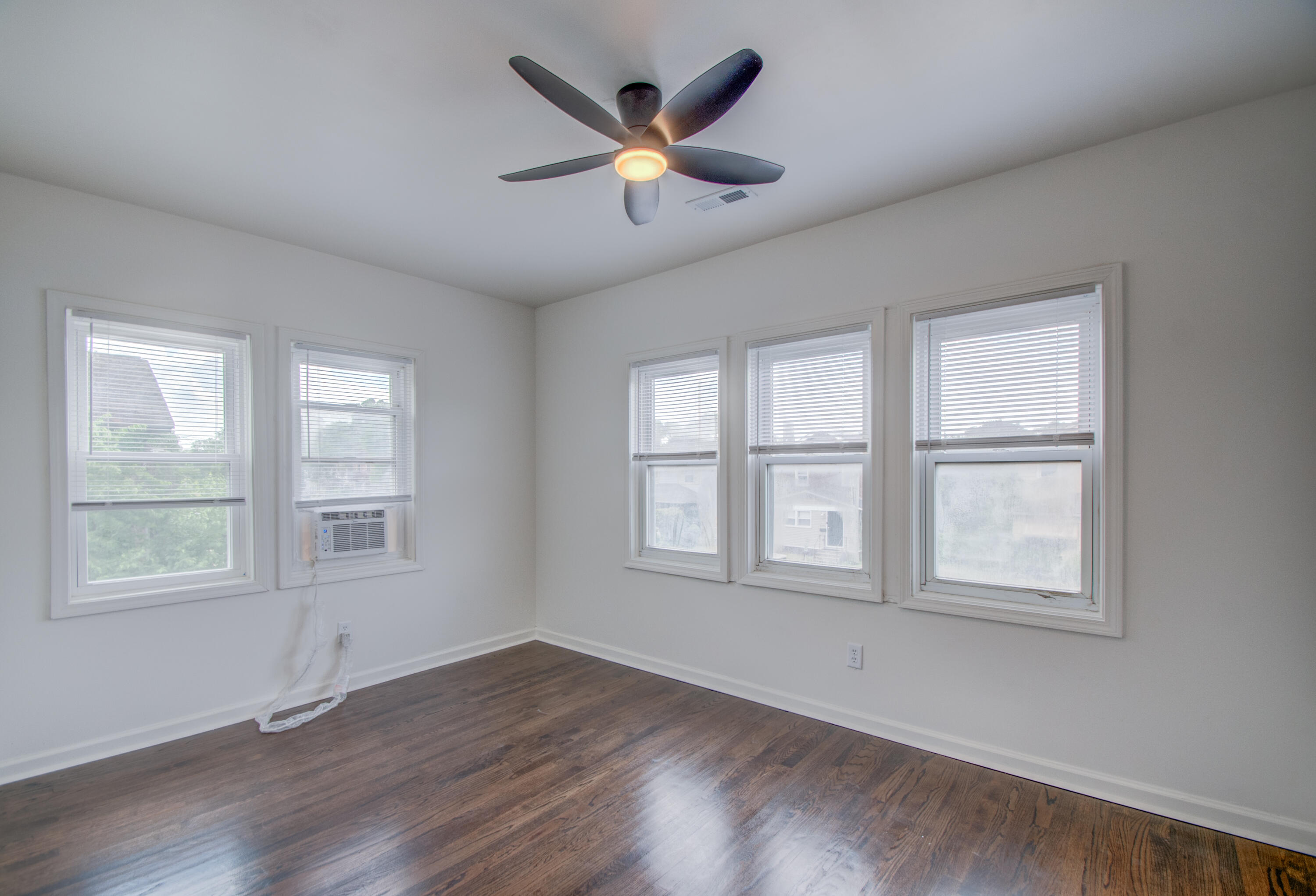 613 Tennessee Street Gary, IN 46402 - Photo 11 of 39 an empty room with wooden floor and windows