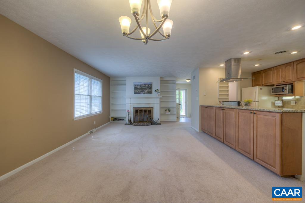 61 Pinewood Court Ruckersville, VA 22968 - Photo 5 of 24 a view of an empty room with a kitchen and a window