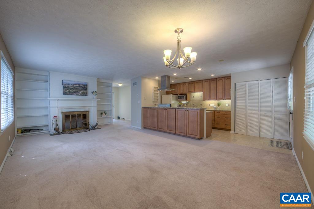 61 Pinewood Court Ruckersville, VA 22968 - Photo 7 of 24 an empty room with kitchen and a fireplace