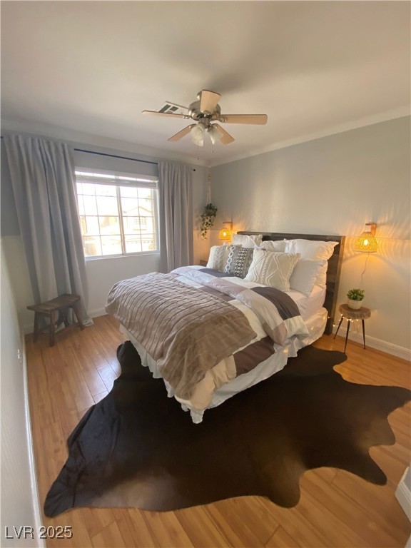 10637 Amblewood Avenue Las Vegas, NV 89144 - Photo 17 of 32 Bedroom with light wood-style floors, ceiling fan, and ornamental molding
