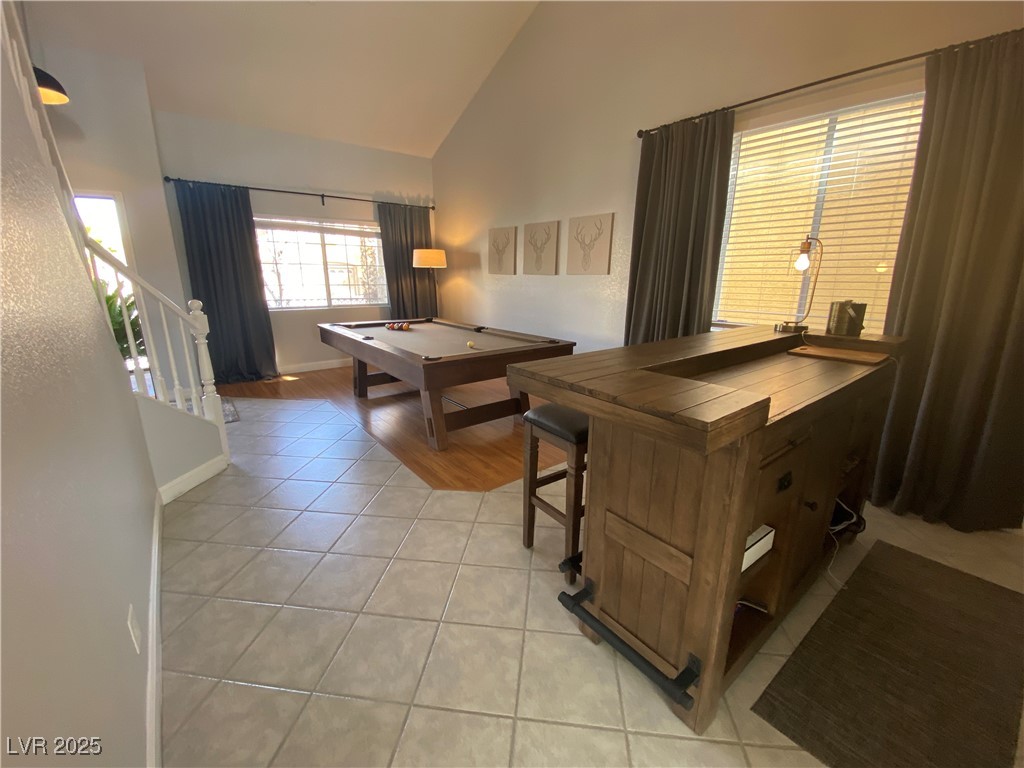 10637 Amblewood Avenue Las Vegas, NV 89144 - Photo 21 of 32 Playroom with light tile patterned floors, high vaulted ceiling, and billiards table