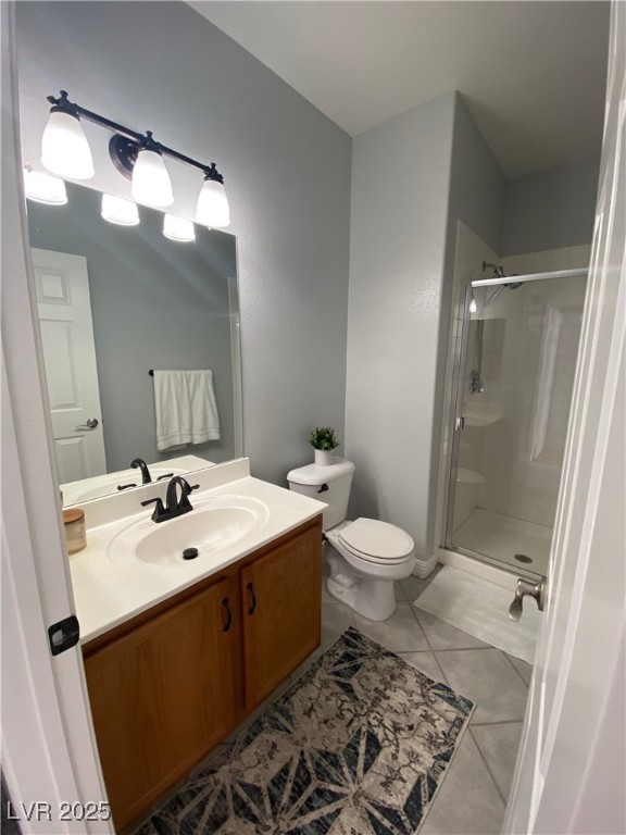 10637 Amblewood Avenue Las Vegas, NV 89144 - Photo 26 of 32 Full bathroom with vanity, a shower stall, and light tile patterned floors