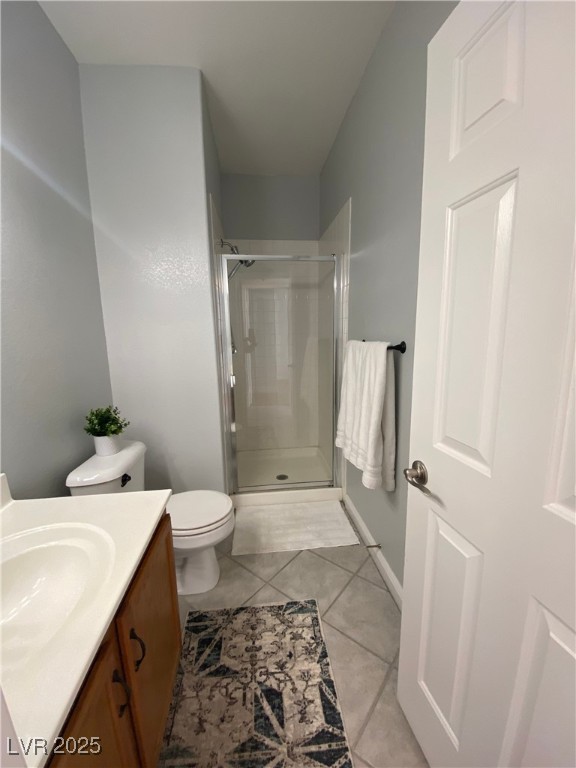 10637 Amblewood Avenue Las Vegas, NV 89144 - Photo 27 of 32 Full bathroom featuring vanity, a shower stall, and light tile patterned floors